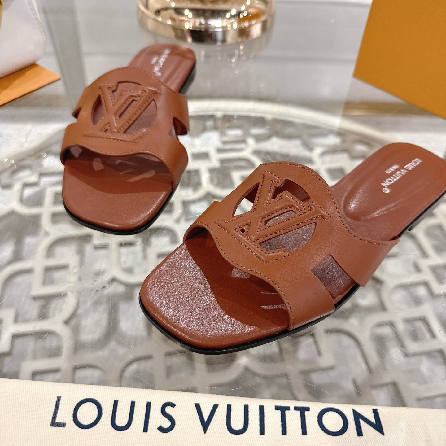 LOUIS VUITTON ISOLA FLAT SLIDE IN PENNY BROWN CALFSKIN