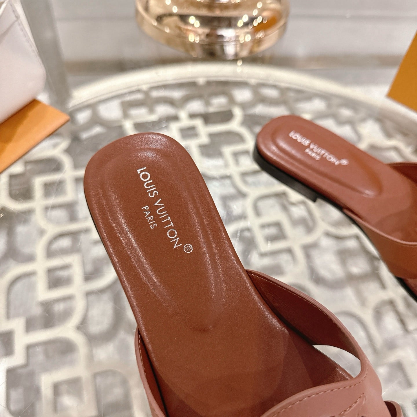 LOUIS VUITTON ISOLA FLAT SLIDE IN PENNY BROWN CALFSKIN