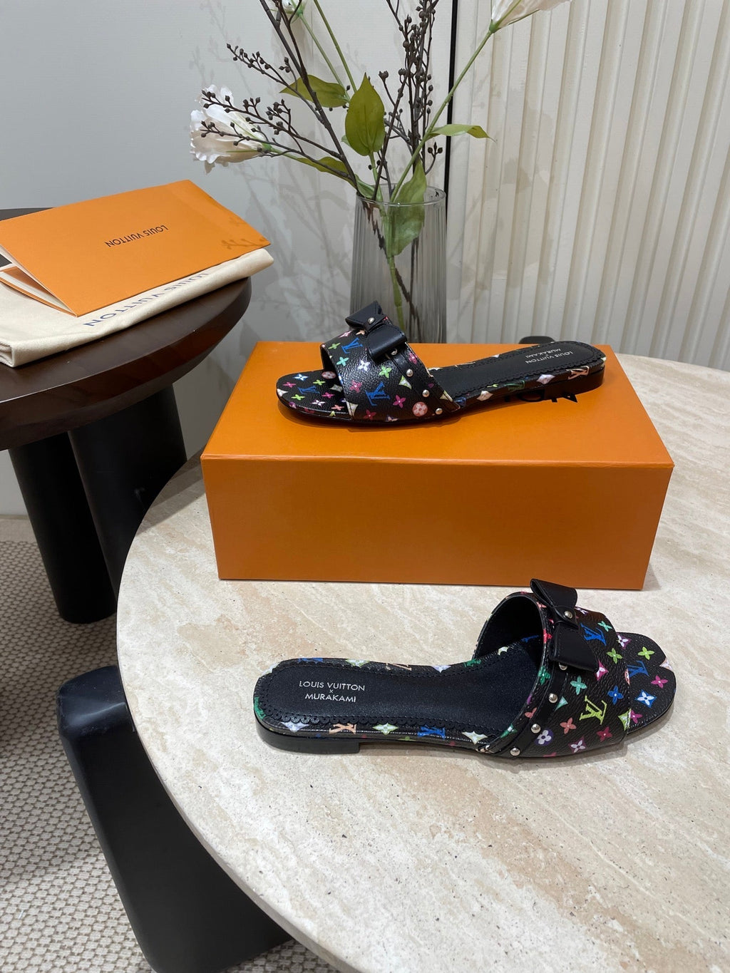 LOUIS VUITTON BOW FLAT MULES IN BLACK MONOGRAM LAMBSKIN