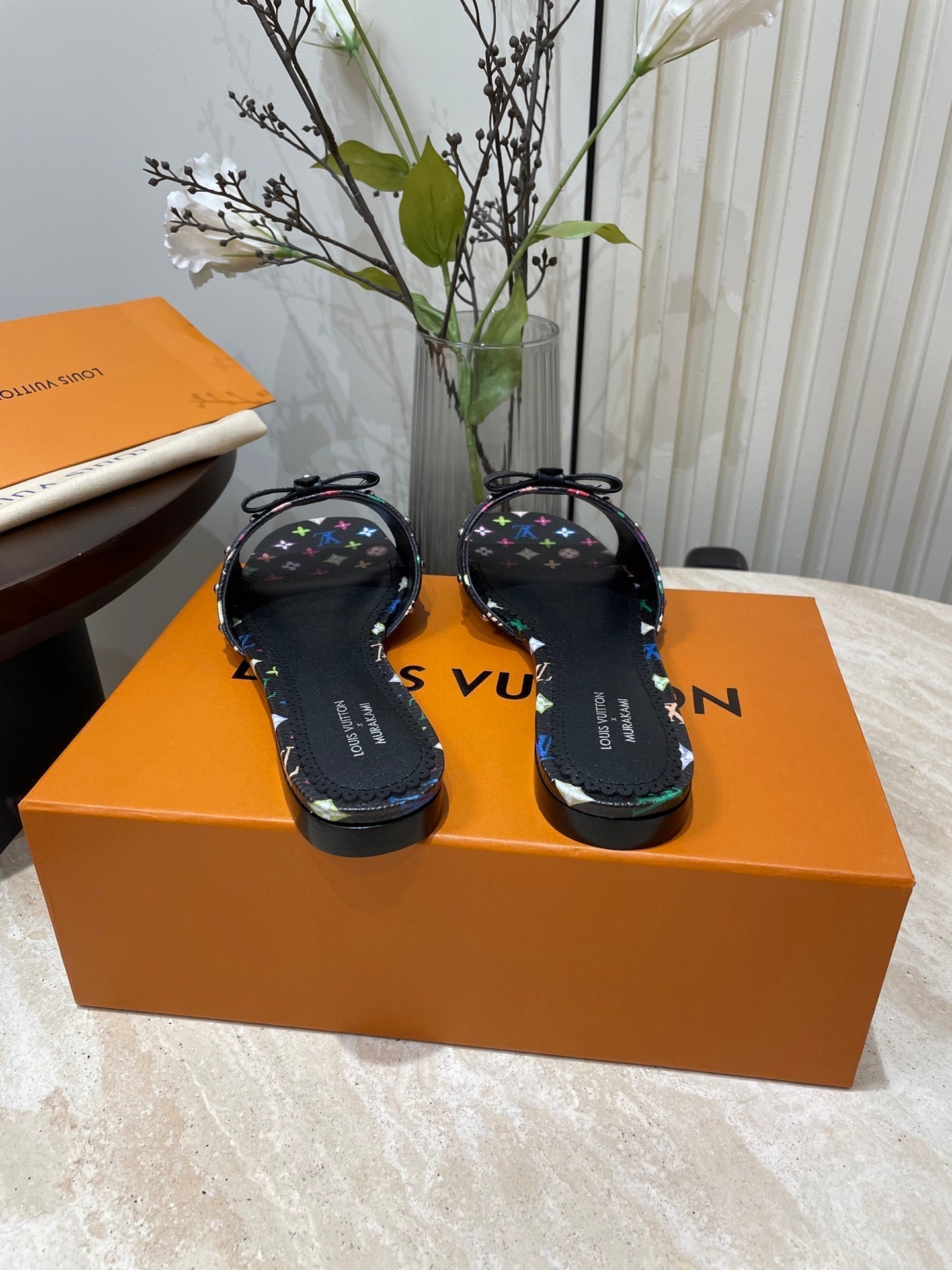 LOUIS VUITTON BOW FLAT MULES IN BLACK MONOGRAM LAMBSKIN