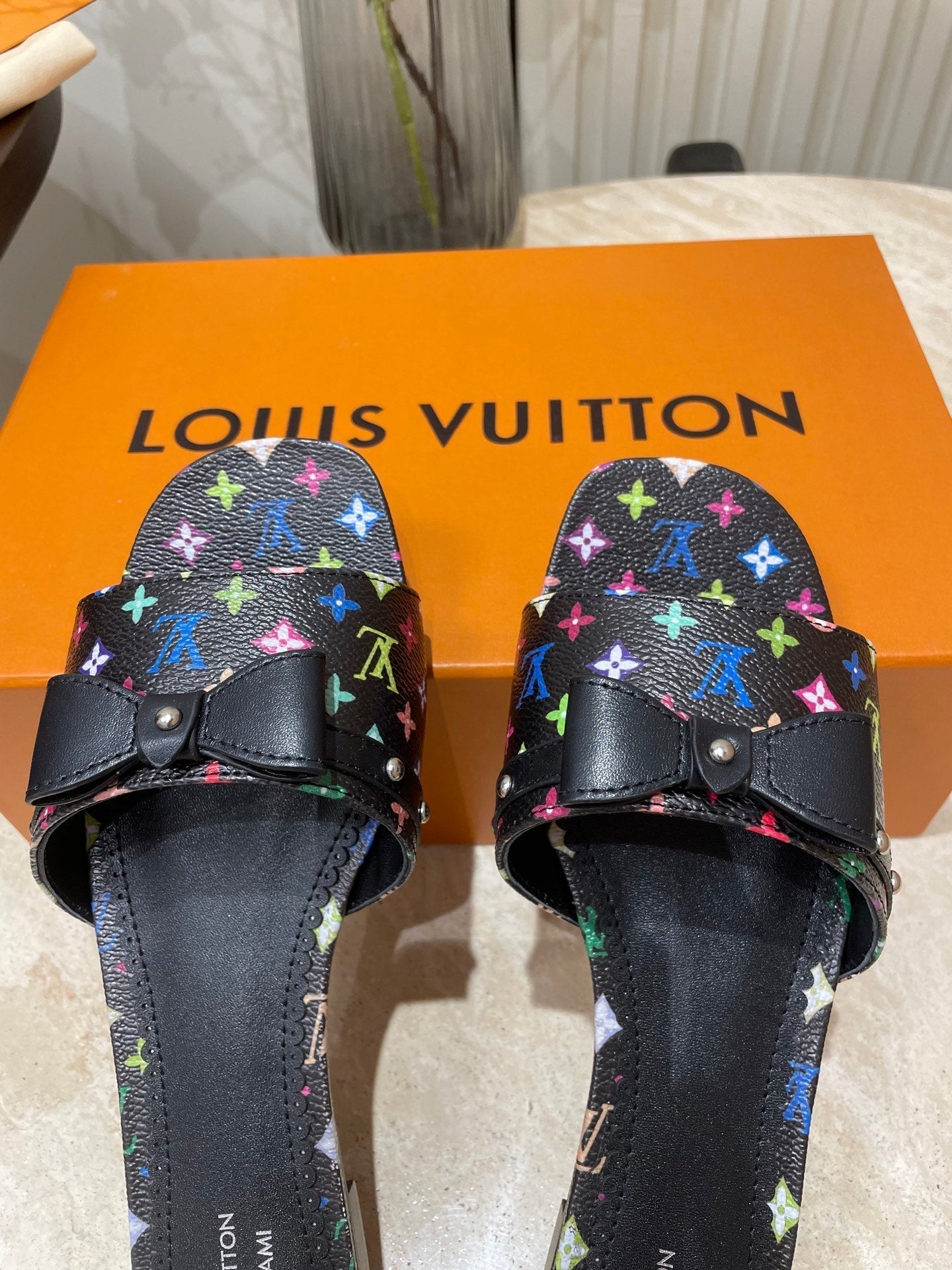LOUIS VUITTON BOW FLAT MULES IN BLACK MONOGRAM LAMBSKIN