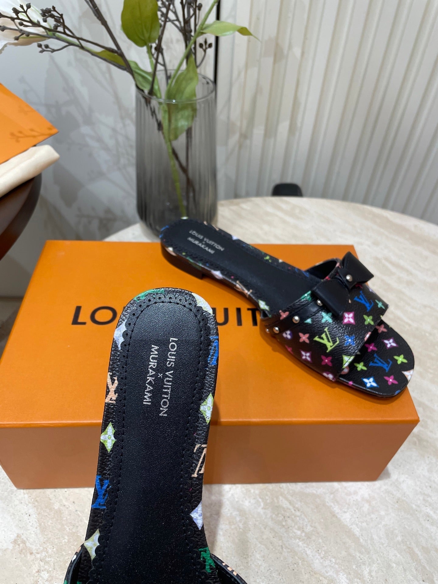 LOUIS VUITTON BOW FLAT MULES IN BLACK MONOGRAM LAMBSKIN