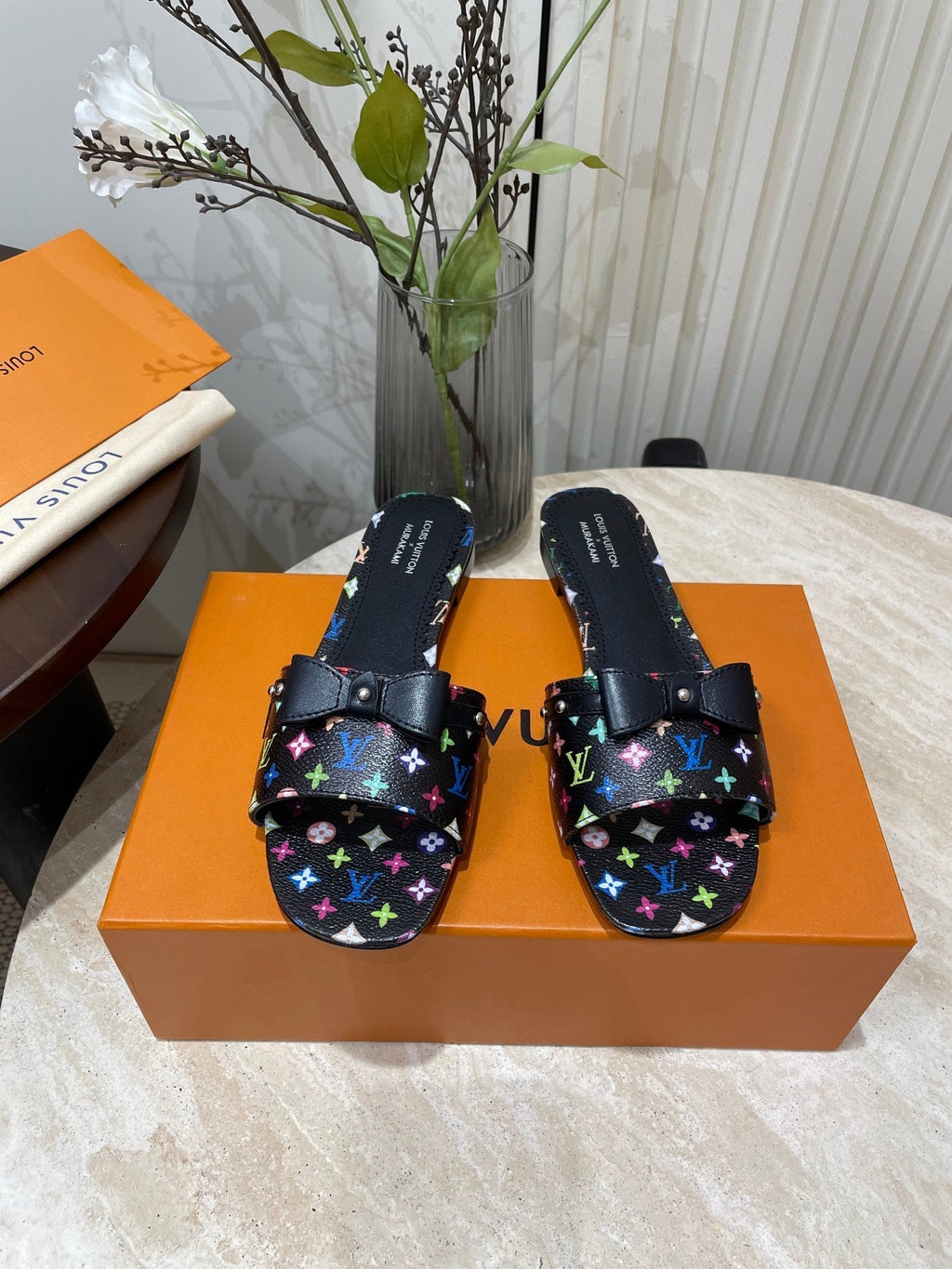 LOUIS VUITTON BOW FLAT MULES IN BLACK MONOGRAM LAMBSKIN